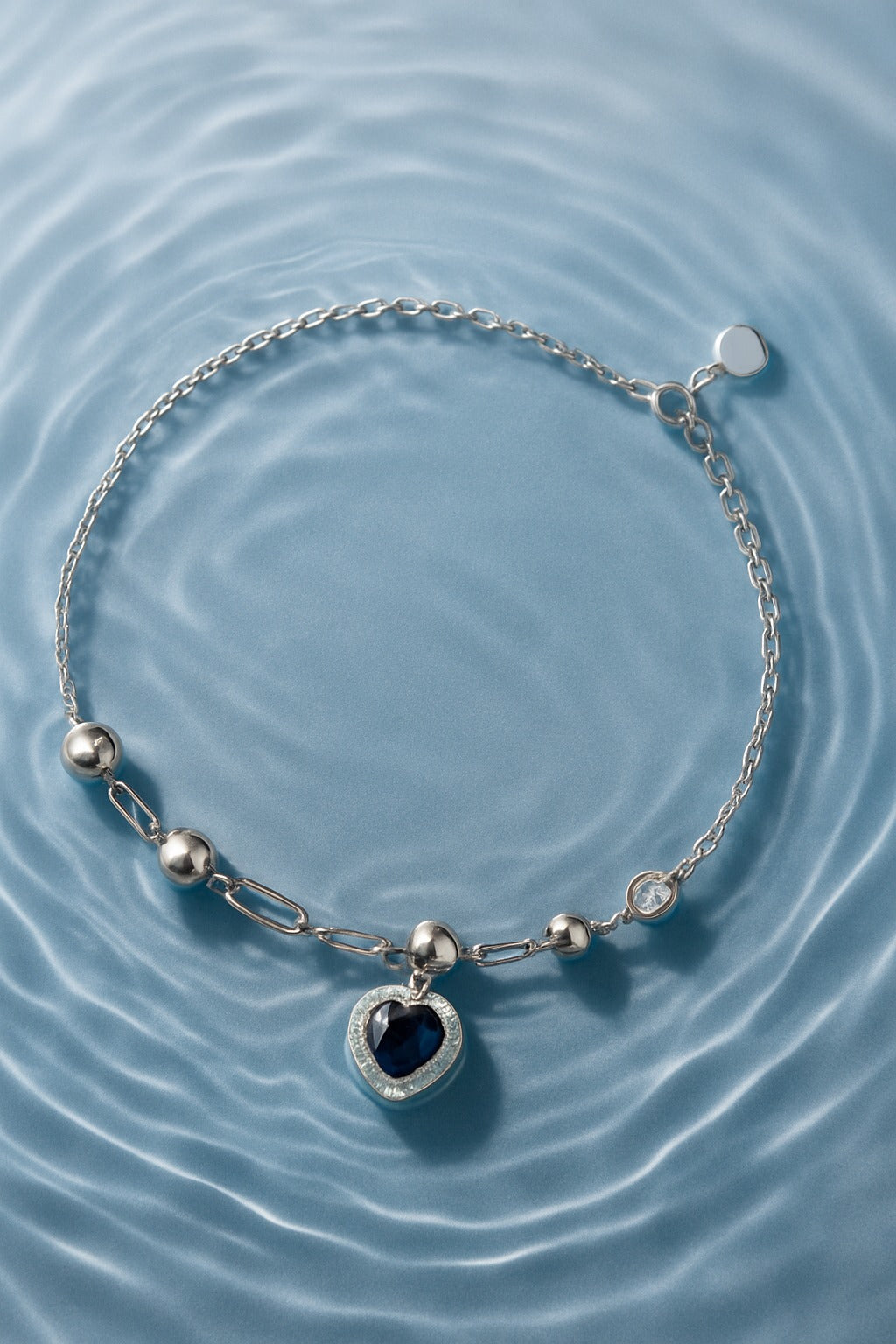 Elegant Heart-Shaped Blue Stone Silver Bracelet with Crystal Accents.