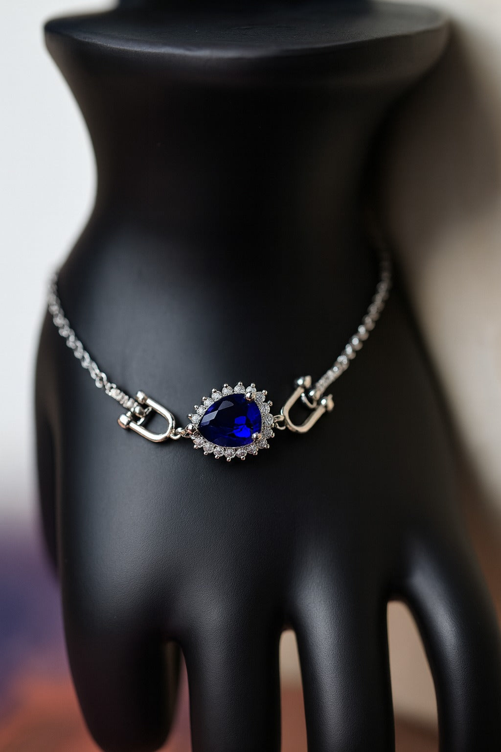 “Elegant Silver Bracelet with Teardrop Blue Stone & Crystal Accents”