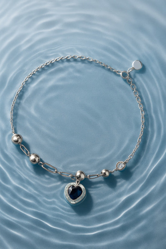 Elegant Heart-Shaped Blue Stone Silver Bracelet with Crystal Accents.