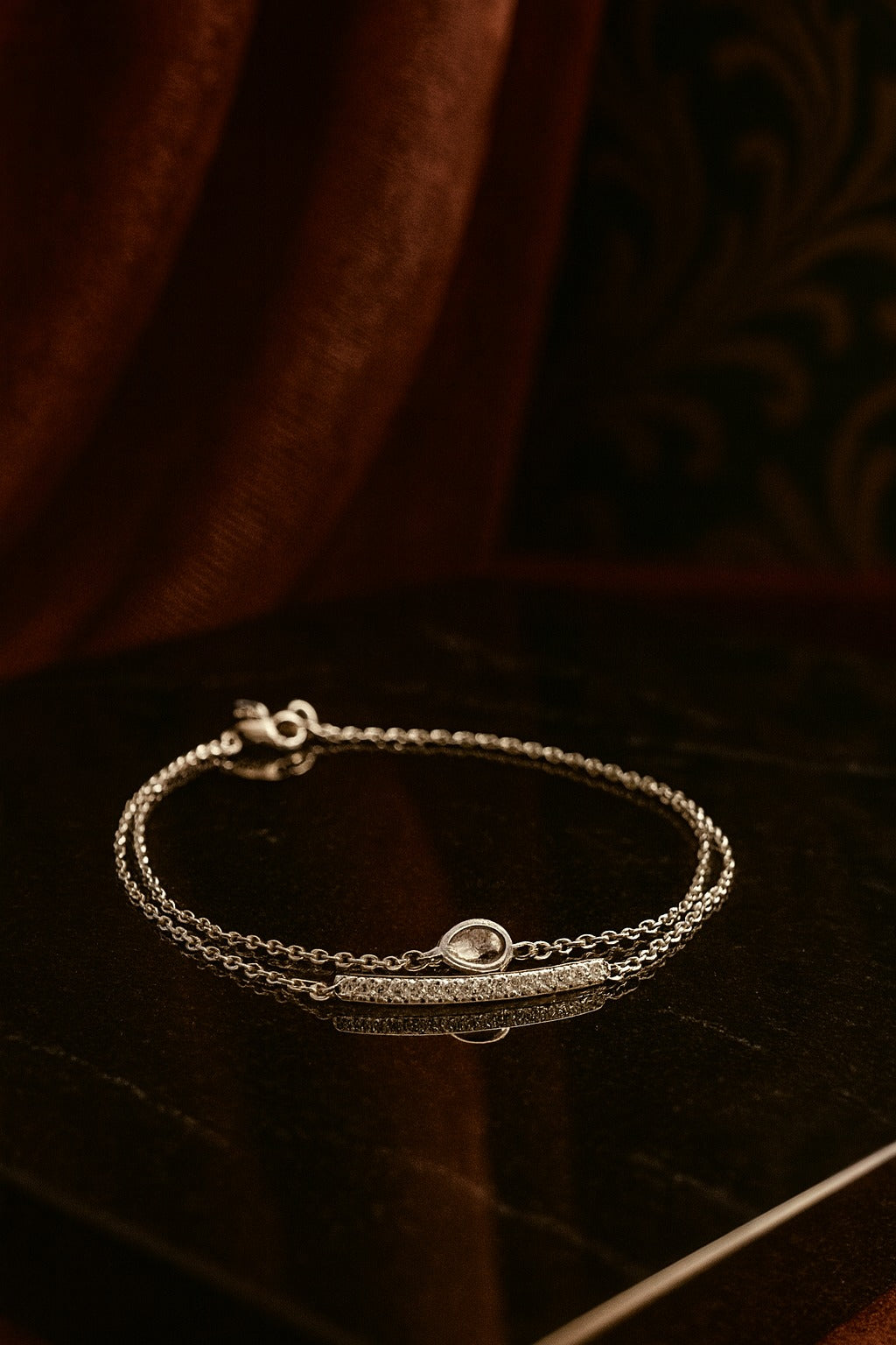 "Delicate Silver Bracelet with Teardrop Green Stone and Dual Chain Design"