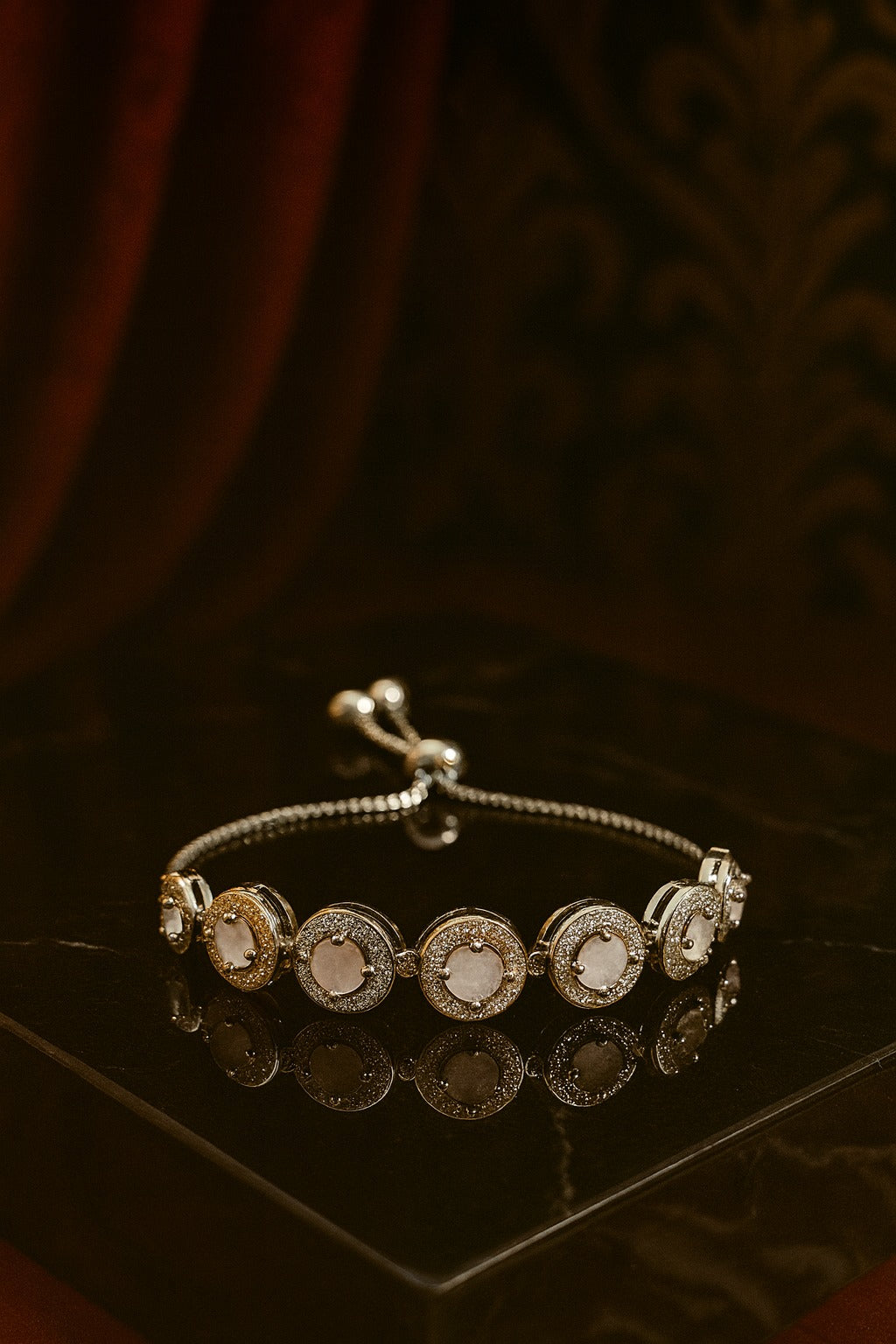 "Elegant Dual-Tone Bracelet with Crystal-Studded Circular Charms"