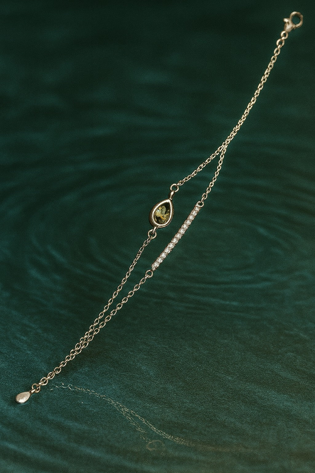 "Delicate Silver Bracelet with Teardrop Green Stone and Dual Chain Design"